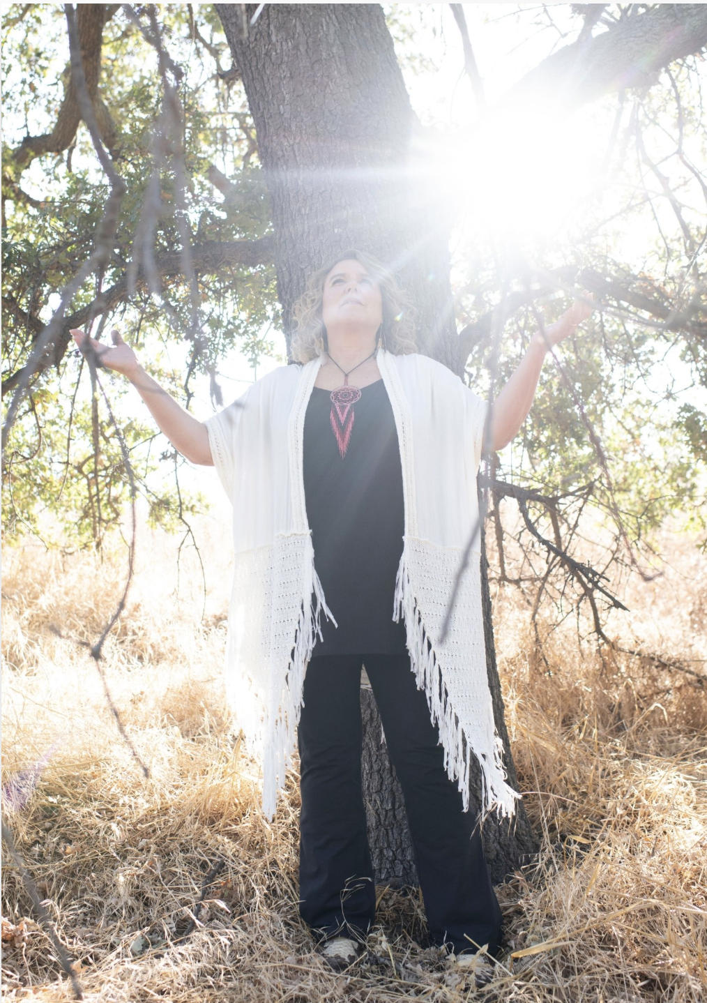Shakti Bottazzi beneath a tree in sunlight
